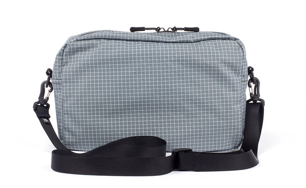 A reverse shot of the Packing Cube Shoulder Bag with a 1" shoulder strap attached